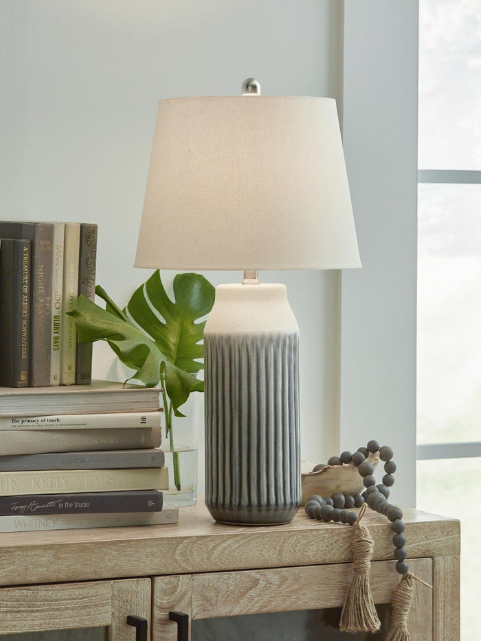 Table lamp with white fabric shade and ribbed dark gray ceramic base