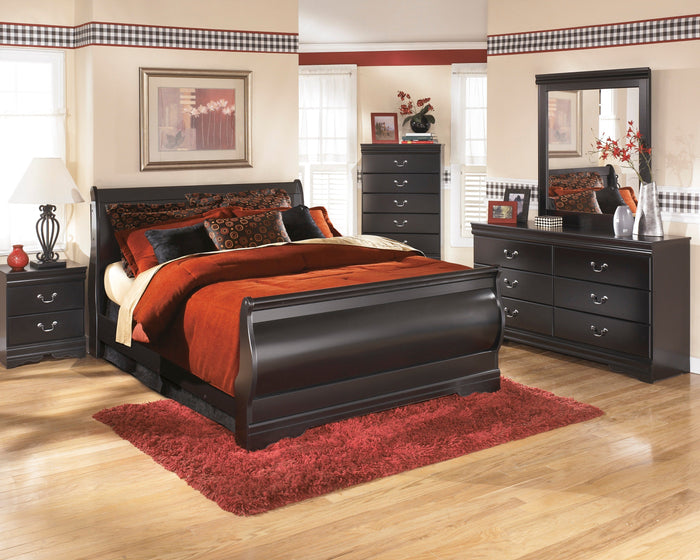 Rectangular bedroom mirror with dark frame on dresser, full-length reflection