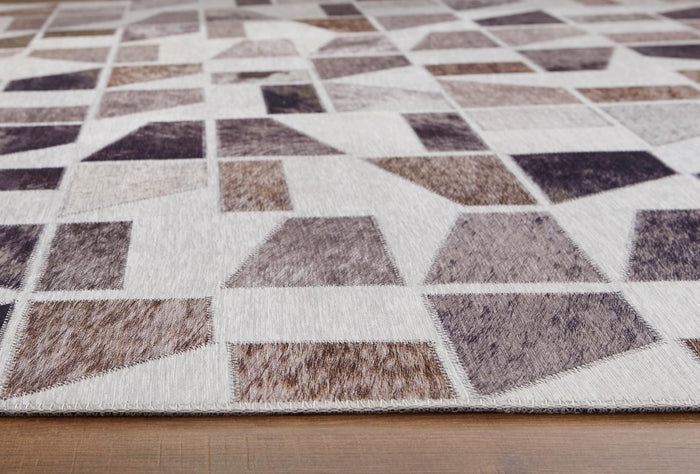 Geometric rug surface with white background and gray-brown block pattern