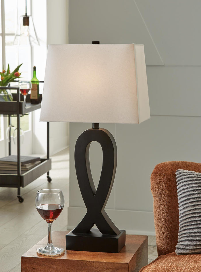 Black table lamp with white square shade and ribbon-shaped base