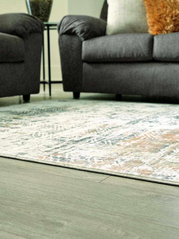 5x7 area rug corner view with distressed teal and gray abstract pattern