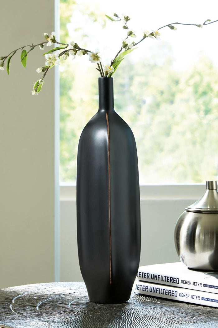 Matte black bottle-shaped vase with copper stripe and small flower stems
