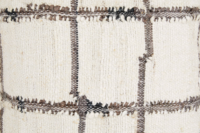 Close-up of plaid pillow fabric with textured weave and dark stitched grid