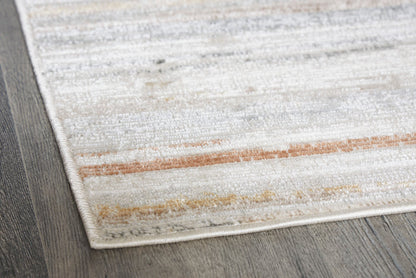 Corner closeup of light gray, cream, and tan striped rug with textured fibers