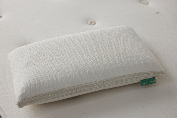 White latex pillow top with textured cover and zipper edge, close-up