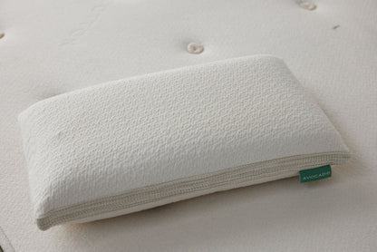 White latex pillow top with textured cover and zipper edge, close-up