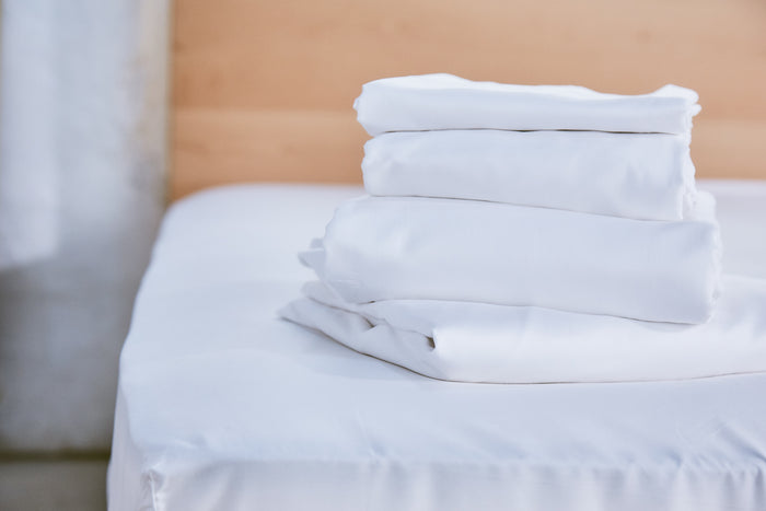 White organic cotton pillowcase stack with smooth folded fabric