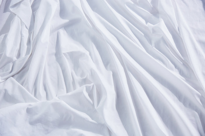 White organic cotton pillowcase fabric with visible wrinkles