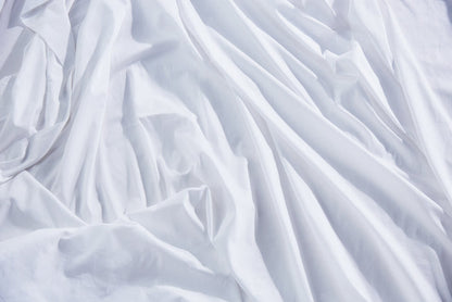 White organic cotton pillowcase fabric with visible wrinkles