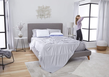 Pillow on bed with gray bedding