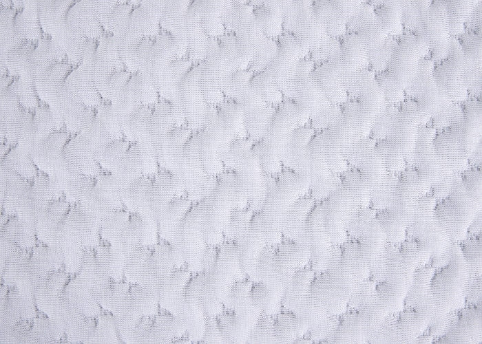 White textured quilted pillow fabric close-up