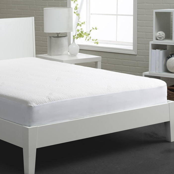 White mattress protector with textured fabric, covering a mattress on a bed
