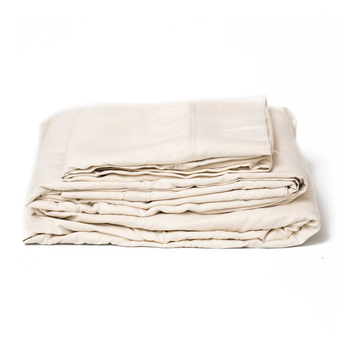 Cream microplush bamboo sheet set folded, front view of layered sheets