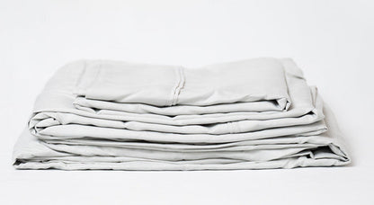 Light gray sheet set stack, folded layers showing seam lines