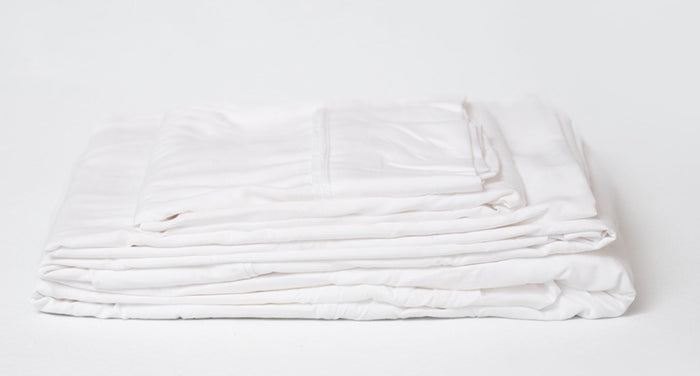 White sheet set folded stack, crisp edges and layered sheet thickness