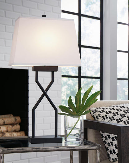Table lamp with white shade and black hourglass-style metal base