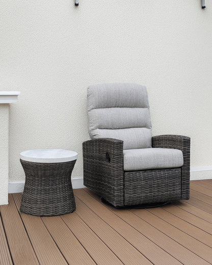 Dark woven outdoor side table with round white top and circular base.