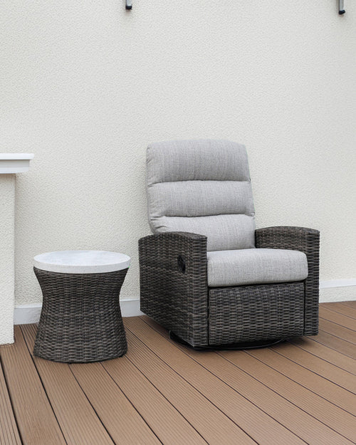 Dark woven outdoor side table with round white top and circular base.