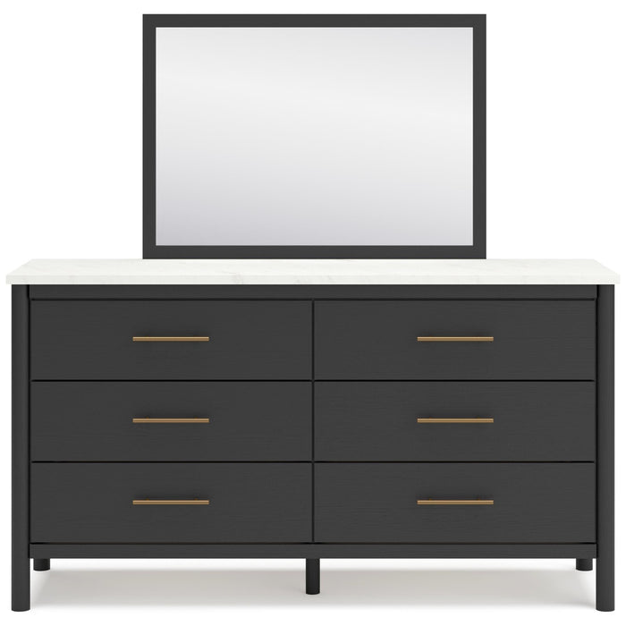 Dark framed wall mirror above black 6-drawer bedroom dresser with bar pulls
