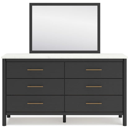 Dark framed wall mirror above black 6-drawer bedroom dresser with bar pulls