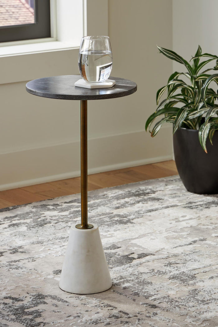 Round accent table with dark round top and gold stem, off-white concrete pedestal base