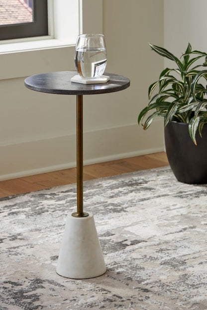 Round accent table with dark round top and gold stem, off-white concrete pedestal base