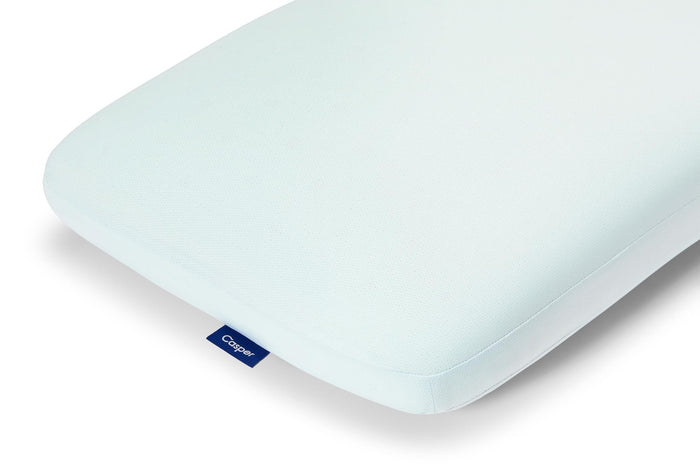 Light blue Casper hybrid snow pillow corner close-up, smooth foam surface and seam line