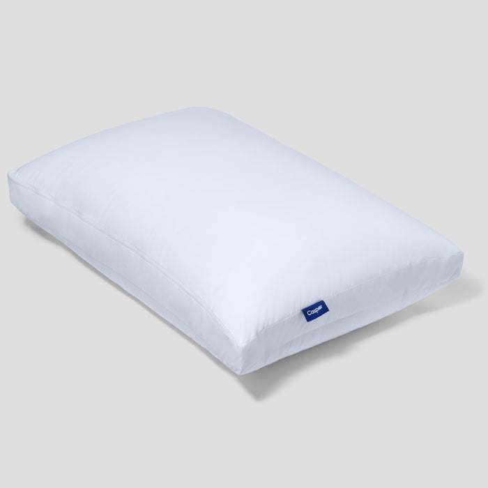 White rectangular Casper logo pillow with a blue tag near the corner.