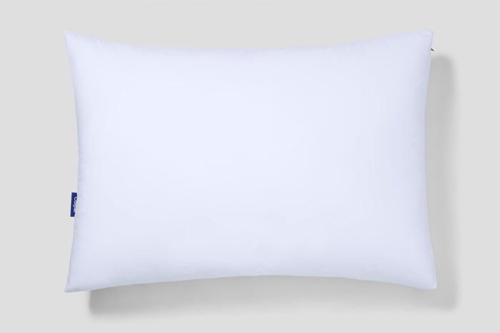 White rectangular pillow with a blue Casper logo patch on the left edge.