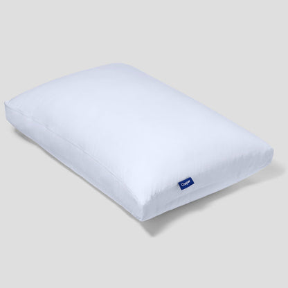 White rectangular pillow with blue Casper logo tag near the front corner.