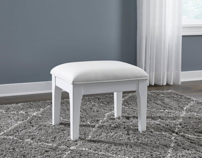 White vanity stool with rounded cushioned seat on four straight legs