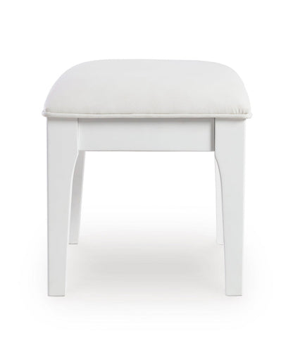 White vanity stool with rounded padded seat and four straight legs