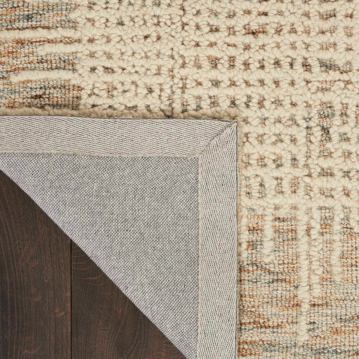 Reversed edge view of textured rug with cream backing and multicolor weave, 2'3" x 7'6"