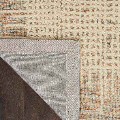 Reversed edge view of textured rug with cream backing and multicolor weave, 2'3" x 7'6"