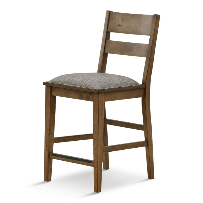 Ladder back dining chair with gray cushioned seat and distressed brown wood frame, angled