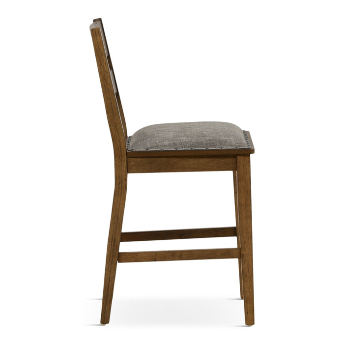 Ladder back dining chair with gray seat cushion and distressed brown wooden legs, side view