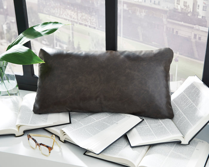 Rectangular decorative pillow, dark brown faux leather look on books and sofa