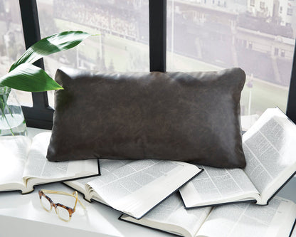 Rectangular decorative pillow, dark brown faux leather look on books and sofa