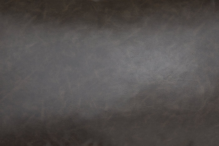 Close-up of dark brown faux leather texture on a lumbar decorative pillow