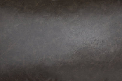 Close-up of dark brown faux leather texture on a lumbar decorative pillow