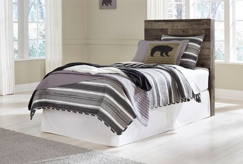 Dark wood panel headboard behind white bed with layered pillows and throw blanket
