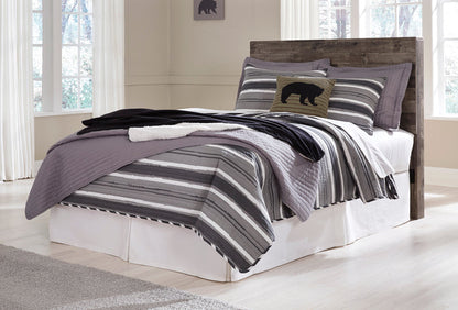 Dark wood panel headboard centered behind white bed with striped bedding