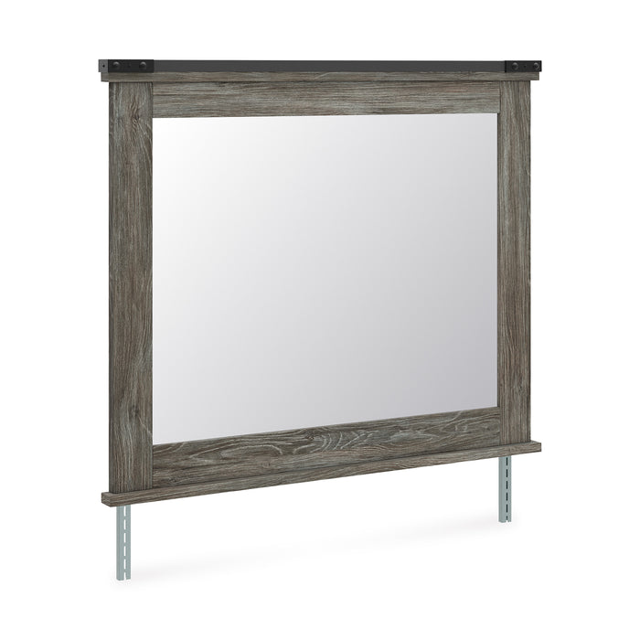 Rectangular bedroom mirror with weathered gray wood frame and visible support legs