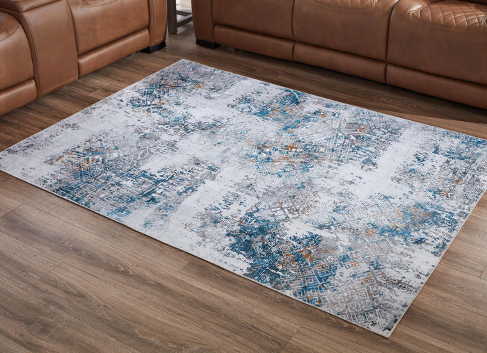 Blue-and-white abstract area rug on wood floor, rectangular 5x7.