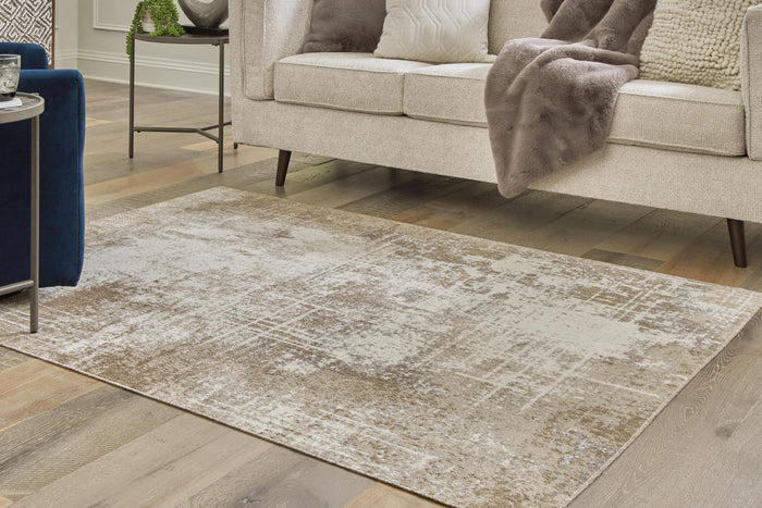 Light beige and ivory distressed rug, rectangular, shown on a living room floor.