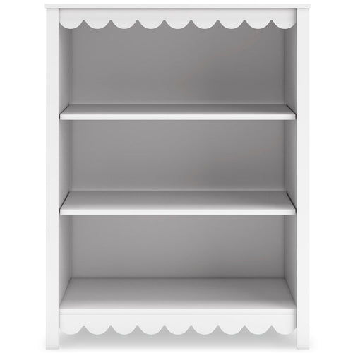 White bookcase with three open shelves and scalloped trim at top and bottom