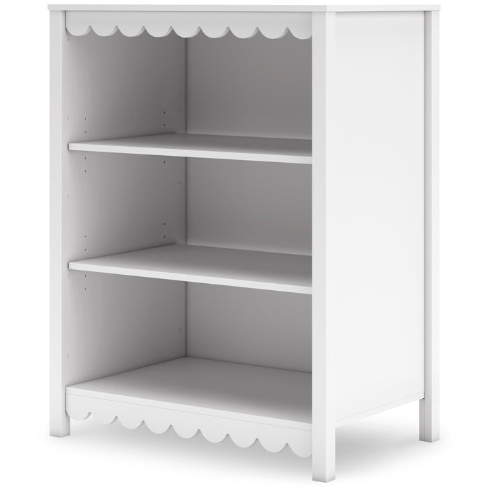 White bookcase side view with three open shelves and scalloped trim