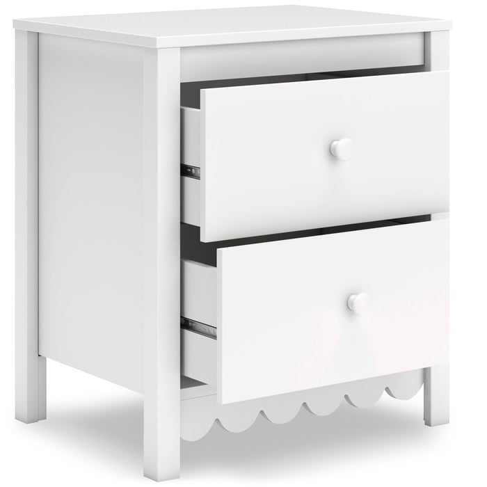 White nightstand with two drawers, one open, and scalloped bottom trim