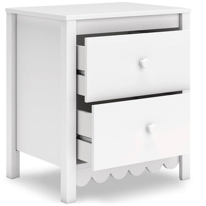 White nightstand with two drawers, one open, and scalloped bottom trim