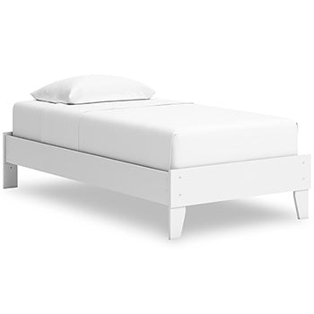 White platform bed with boxy headboard, footboard, and tapered legs
